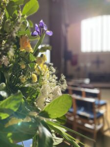 Flowers with cross in the background